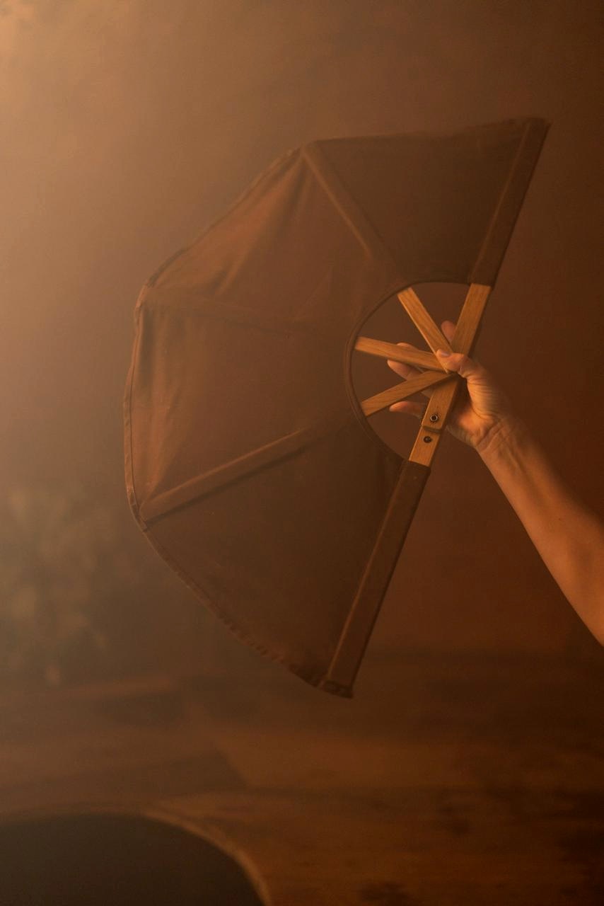 Steam guide passing a leaf whisk to seated guests inside the dome